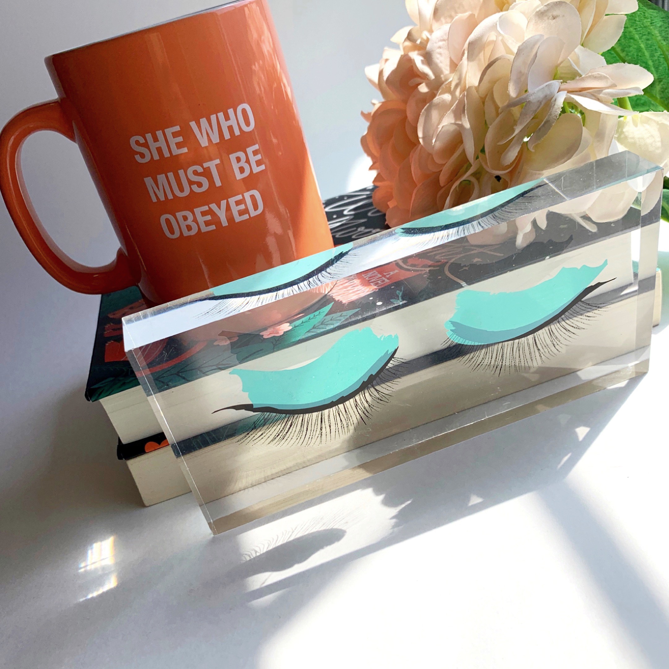 bookstack mug and feminine eyelashes