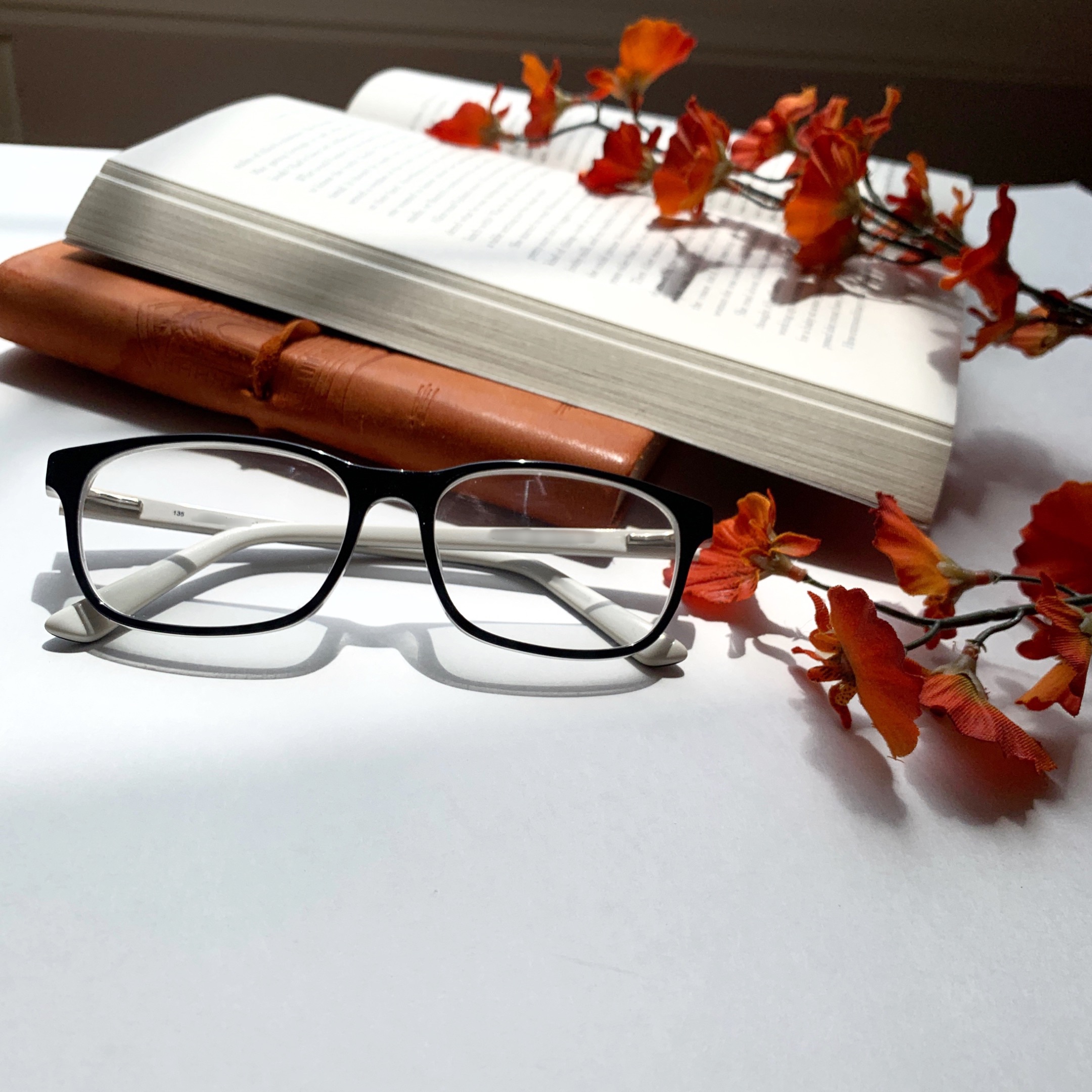 Book with glasses and flowers